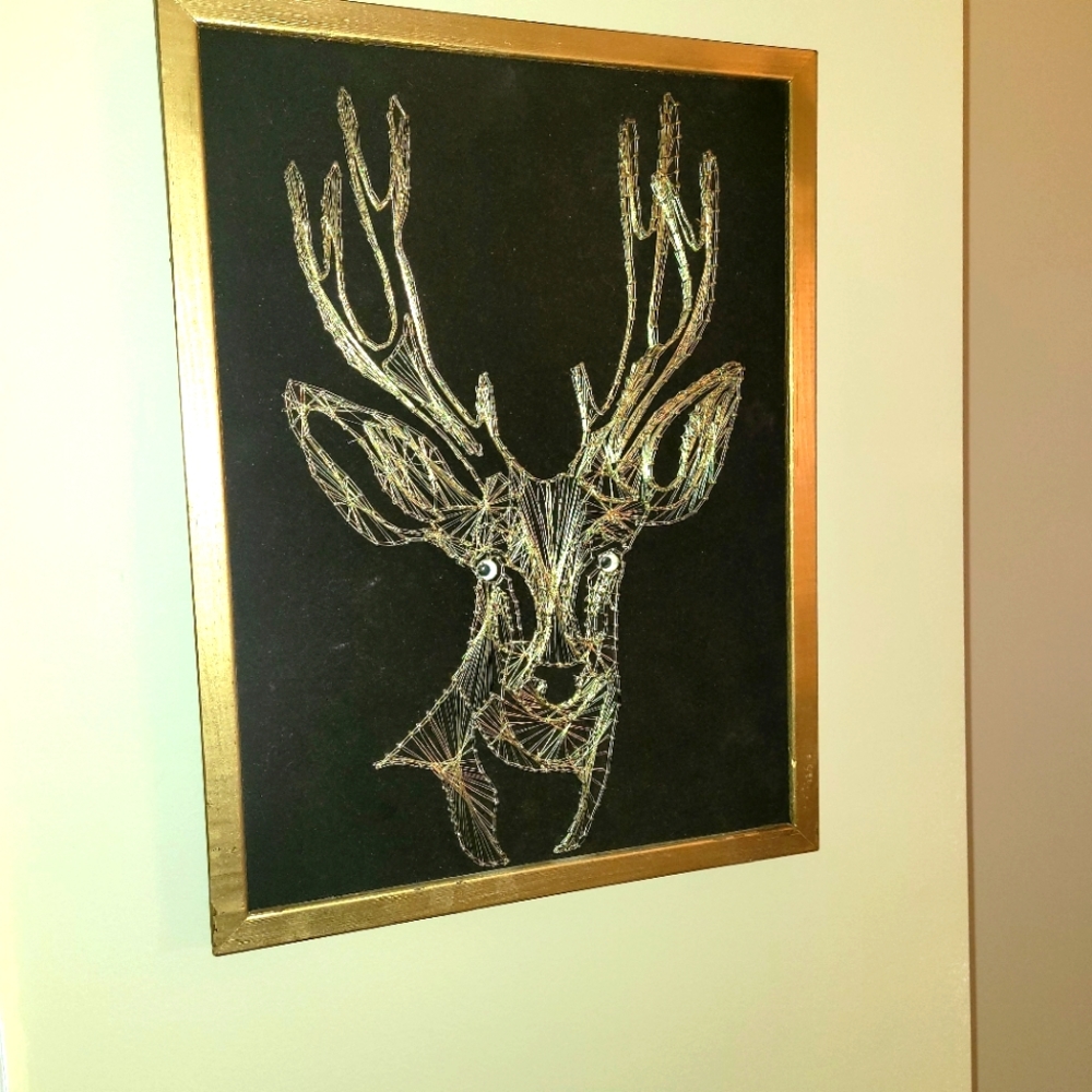 Vintage reindeer string art on black velvet
